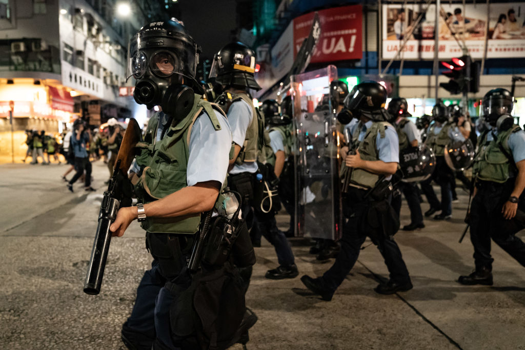 Police charge on a street during a demonstration on Hungry Ghost Festival day in Sham Shui Po district on August 14, 2019 in Hong Kong, China. 