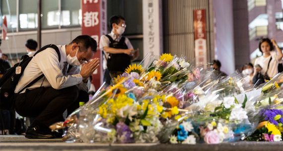 A man prays at a site outside of Yamato-Saidaiji Station where Japan’s former prime minister Shinzo Abe was shot during an election campaign on July 08, 2022 in Nara, Japan