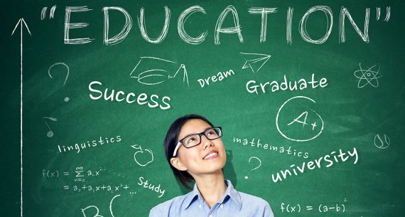 teacher in front of a blackboard with brainstorming words 