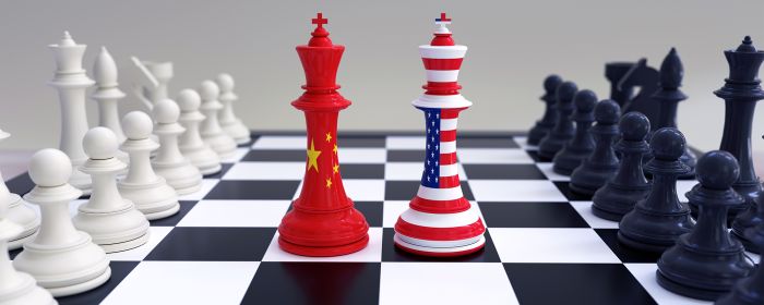Chinese and American flags on chess pieces on chessboard
