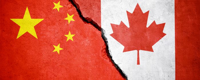 China and Canada flags joined by a fracture line